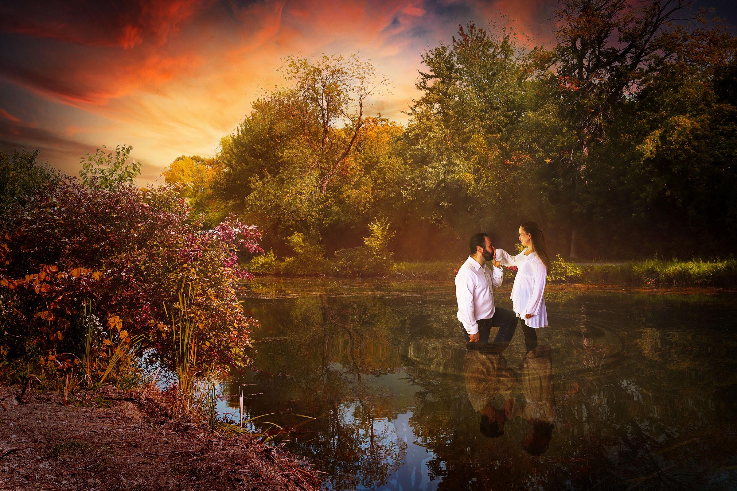 Composite couple male female standing in water male kneeling and kissing female hand colorful trees and reflection of couple in water by Vaudreuil-Soulanges and West Island of Montreal photographer Tobi Malette