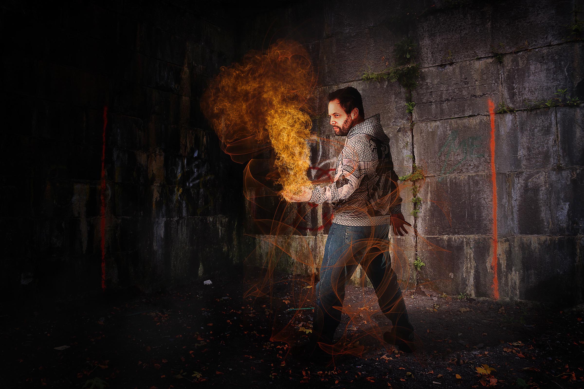 Composite of man standing with flame in hand night scene with stone wall background by Vaudreuil-Soulanges and West Island of Montreal photographer Tobi Malette