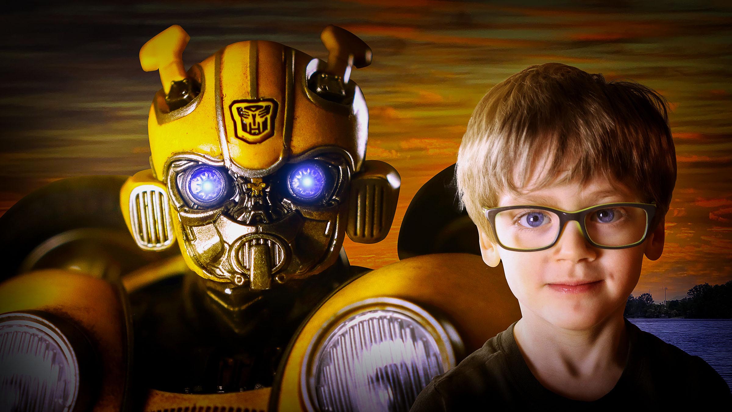 Composite of boy and Transformers Bumblebee close up of heads with blue and orange sky background by Vaudreuil-Soulanges and West Island of Montreal photographer Tobi Malette