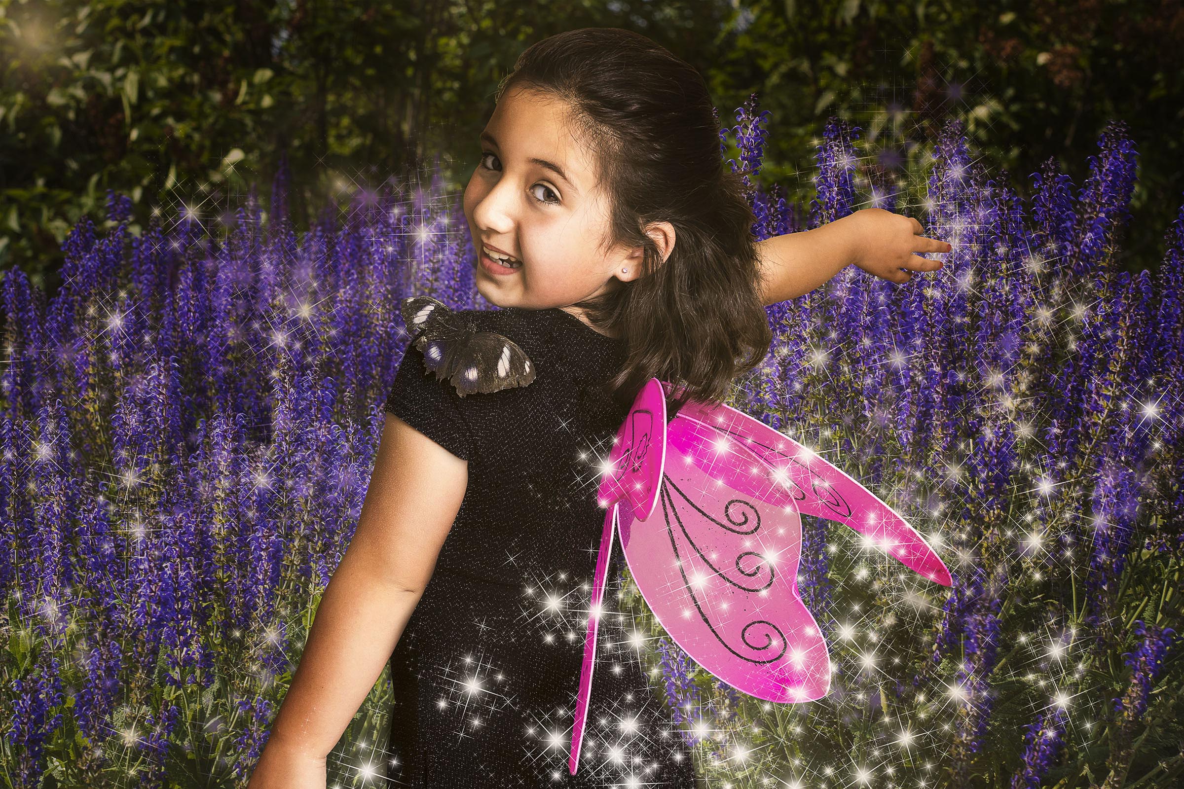 Composite of girl with pink wings black dress and butterfly on shoulder with flower background by Vaudreuil-Soulanges and West Island of Montreal photographer Tobi Malette